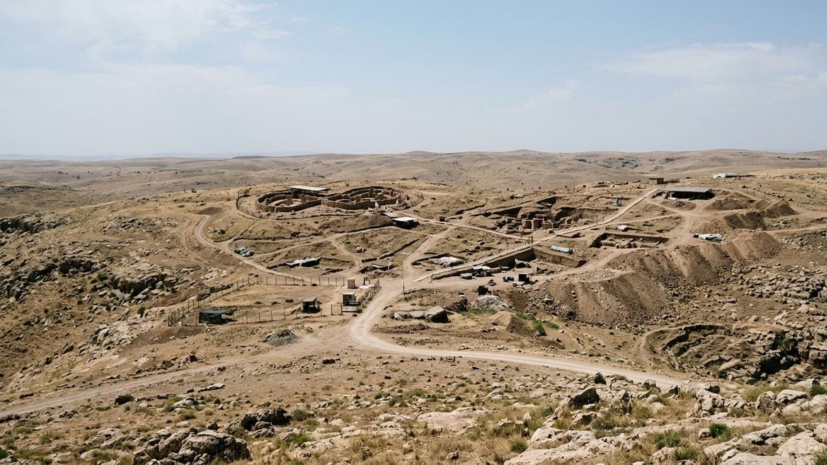 Vista amplia de la meseta arqueológica de Göbekli Tepe con rastros de excavación y paisaje seco alrededor
